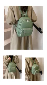 Stylish green leather mini backpack for women, casual trendy fashion daypack with silver zippers.