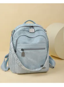 Close-up detail of casual Oxford cloth backpack, showing front zipper pocket and stylish strap.