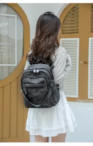 Casual multi-pocket canvas backpack for women, stylish large capacity travel bookbag.