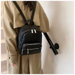 Women's black soft leather backpack, trendy casual daypack with durable metal zippers for daily use.