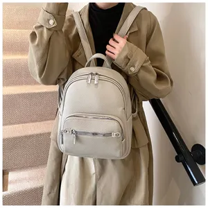 Detail view of stylish women soft leather backpack with zipper pockets, casual daypack.