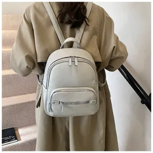 Detail view of women's soft leather backpack, casual fashion daypack with double zippers in beige.