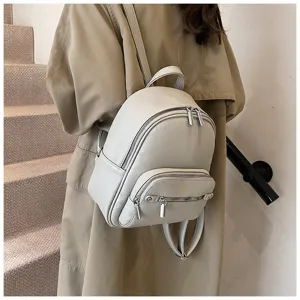 Detailed view of women soft leather backpack, stylish minimalist casual daypack in light gray.