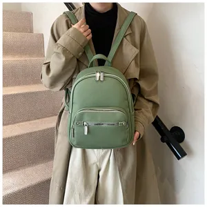 Green leather backpack for women, stylish and casual daypack with multiple zipper pockets.