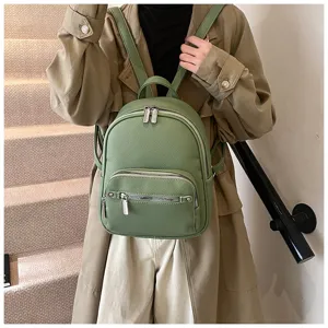 Detailed view of stylish soft leather green backpack, showing fine texture and design.
