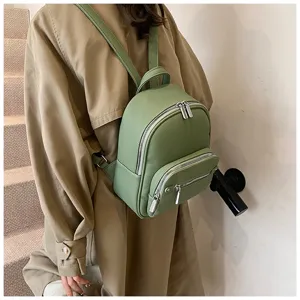 Casual green soft leather backpack detailed view showing texture and metal zippers