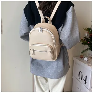 Stylish minimalist soft leather backpack for women, casual daily daypack with zipper pockets.