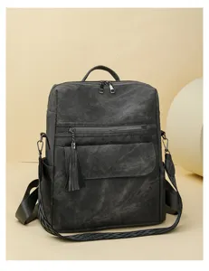 Women vintage soft leather backpack with stylish tassel charm, multi-functional travel school bag.