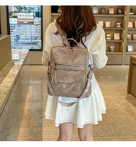 Retro soft leather women's backpack, multi-functional travel shoulder bag with stylish tassel.