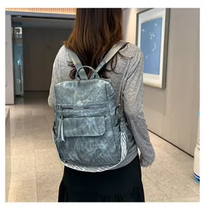 Korean vintage women's soft leather backpack with tassel, stylish multi-functional travel bag.