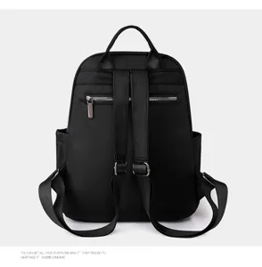 Backpack detail view showing rear adjustable straps, metal zippers, and durable fabric.