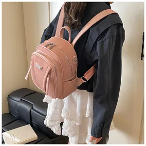 Detailed view of women pink leather backpack, casual daily travel school daypack with multi pockets.