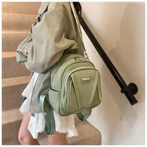 Detailed view of stylish green PU leather casual backpack for women, highlighting daily wear.