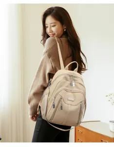 Stylish women leather backpack with zip pockets and chic lock, ideal for travel use.