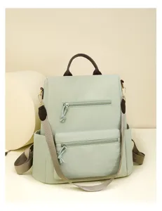 Green casual women backpack detail view with multi compartments and front zipper pockets