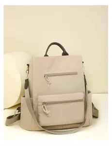 Detailed view of the beige multi-pocket casual backpack featuring smooth zippers and durable straps.