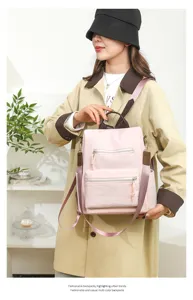 Detailed view of the pink casual women's backpack, featuring multi-compartment design.