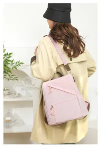 Casual pink anti-theft backpack detail view showing stylish strap and compartment.