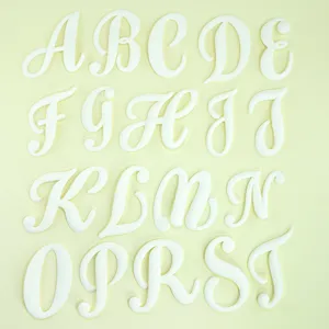 Gedetailleerde close-up van witte alfabetbedels, ontworpen als decoratieve DIY-tasaccessoires.