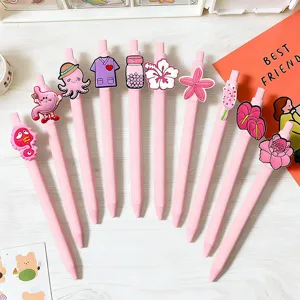 Detailed view of pink gel pens featuring cute cartoon silicone toppers and smooth ink writing.