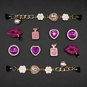 Detailed view of pink white and purple alloy shoe charms and chain sets for clogs and DIY bags.