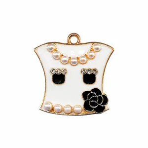Metal shoe charm detail featuring pearls, rhinestones, and elegant black camellia flower design.