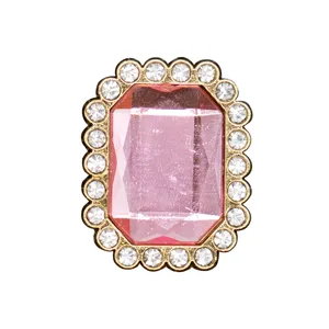 Close-up detail of the sparkling pink rectangular rhinestone shoe charm with gold scalloped edge.