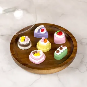 Closeup of cute 3D miniature cake PVC shoe charms, colorful DIY decorative accessories.