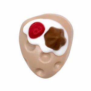 Close-up detail of a cute 3D cake shoe charm, PVC material accessory for clogs.
