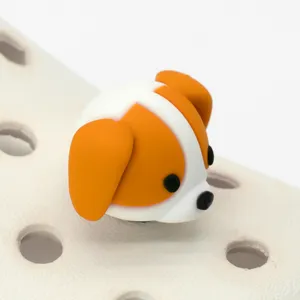 Close-up detail shot of a cute 3D orange and white puppy dog shoe charm on clogs.