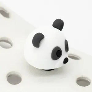 Close-up detail of 3D panda shoe charm, cute cartoon animal jibbitz decoration for clogs.