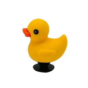 Yellow duck figurine detail view, cute animal shoe charm and small desktop decor.