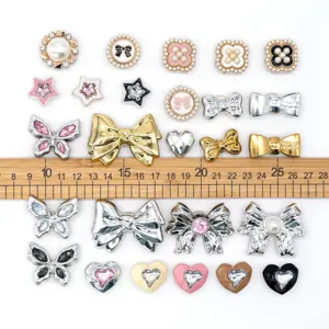 Detailed view of luxury style black white pearl metal shoe charms set for clogs bags