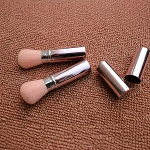Retractable pink makeup brush portable cosmetic tool for loose powder and blush design.