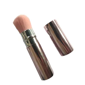 Portable retractable makeup brush with pink bristles and rose gold metallic case for beauty