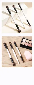 Double-ended makeup brush set featuring black and white handles for precise eye shadow blending.