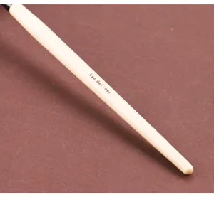 Detailed close-up view of the eye definer makeup brush handle, showcasing precise cosmetic craftsmanship.