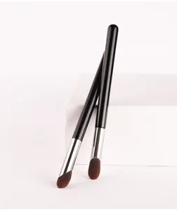 Detail shot of professional makeup concealer brushes with soft fibers and sleek black handles.