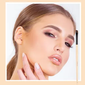 Professional angled eyebrow makeup brush with natural wooden handle for precise definition.