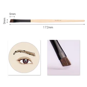 Professional angled eyebrow brush with wooden handle for precise makeup application.