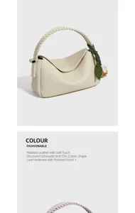 Chic borsa a tracolla in pelle martellata con manico intrecciato e ciondolo a foglia verde.