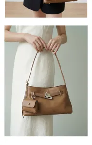 Detailed view of brown genuine leather shoulder bag with lock clasp and mini pouch for women.