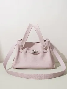 Bolso de mano en cuero rosa con asas y correa de hombro ajustable para mujer chic.