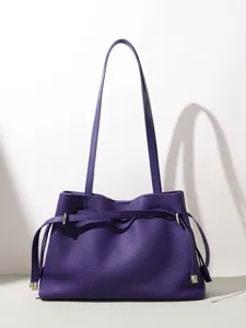 Elegant purple leather shoulder bag for women, minimalist tote with drawstring and long straps.