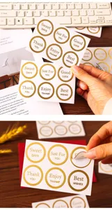 Gold stamped round sealing sticker detail view displaying elegant English blessing text.