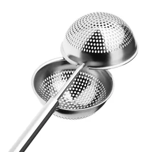 Stainless steel tea infuser mesh detail, squeeze handle design for easy tea brewing closeup.