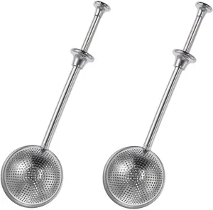 Detail view of stainless steel push tea infuser strainer sphere tool for loose leaf tea.