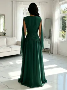 Detalle de vestido largo de gasa verde oscuro con elegantes mangas capa y diseño entallado.