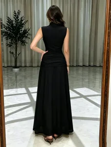 Black sleeveless ruched maxi evening dress detail, elegant draped mesh party gown style.