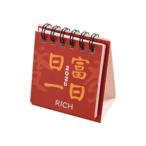 2026 mini desktop calendar, red spiral bound daily planner for office and student use.